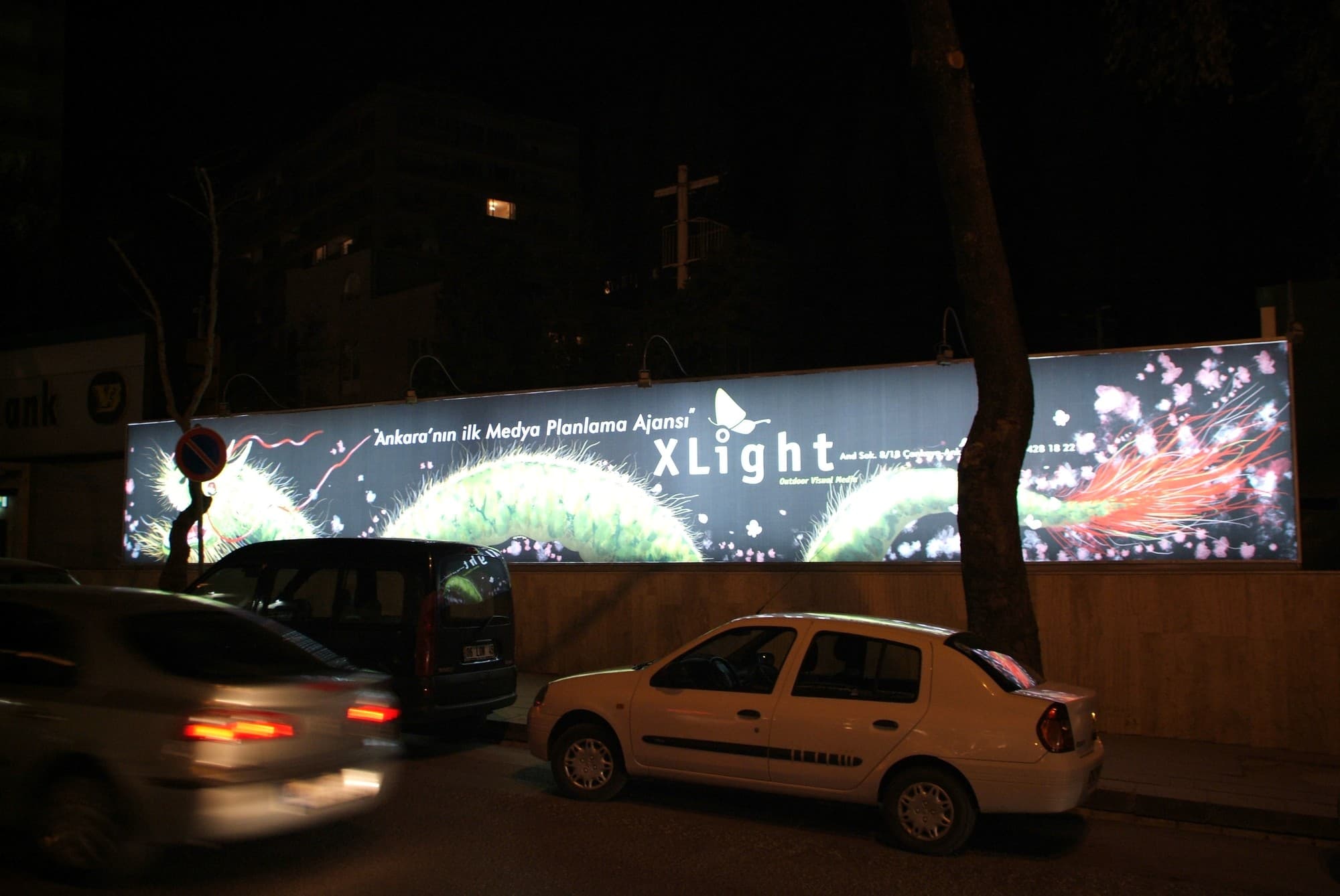 XLight panel wall seen from the street at night with parked cars in front, Ankara (archive, 2006)